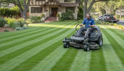 Commercial mower creating precise striped lawn patterns during professional mowing in Pasadena, CA
